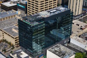 An ariel view of the University District Station Building in the daytime. UW Tower is visible behind it.