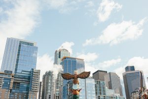 A carved eagle faces the downtown skyscrapers